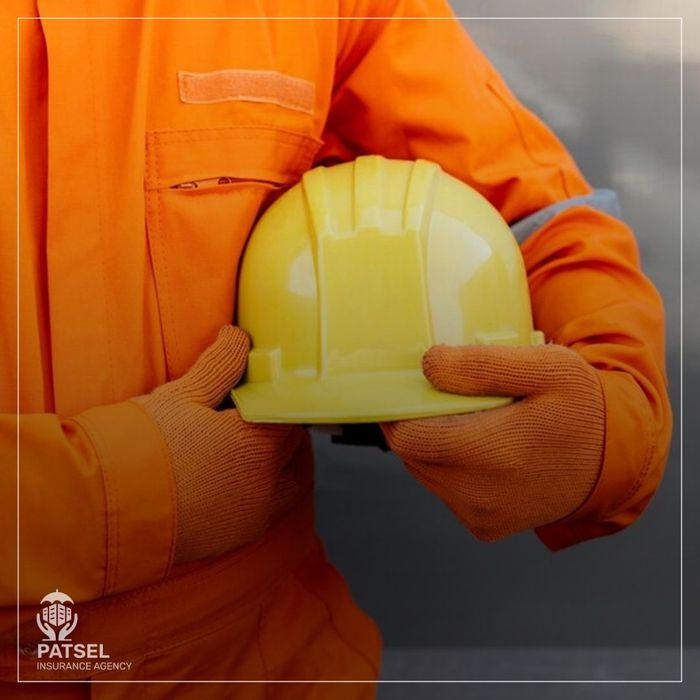 worker holding hard hat under arm