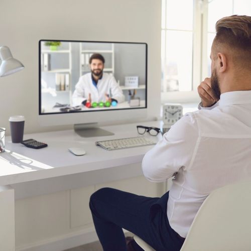 A man having a convenient and positive telehealth consultation with his doctor via laptop. A man having a convenient and positive telehealth consultation with his doctor via laptop.