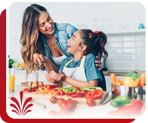 happy woman cooking in the kitchen with her daughter