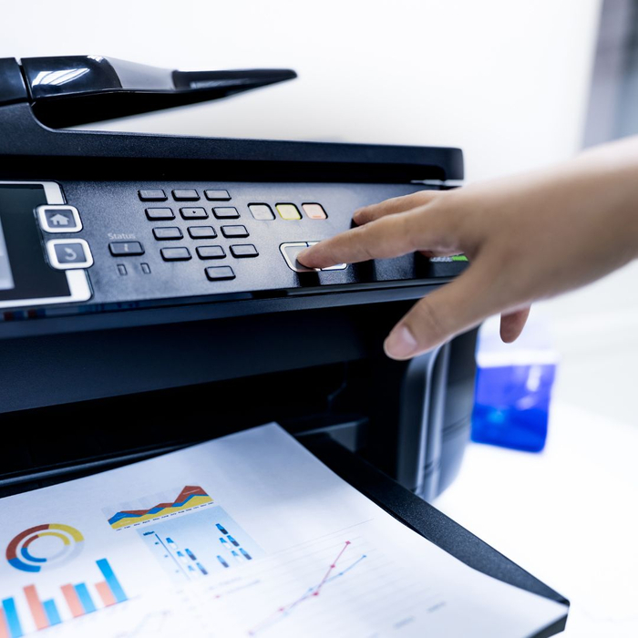 person touching buttons on printer