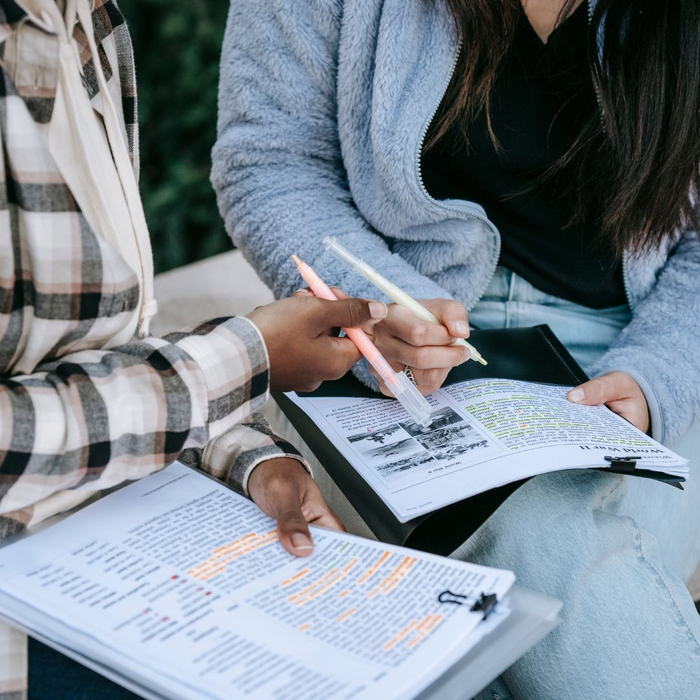 students highlighting printed documents