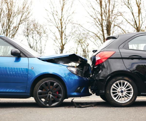 a blue car rear ending a black car