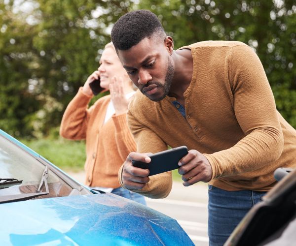 a man taking a photo of a car accident