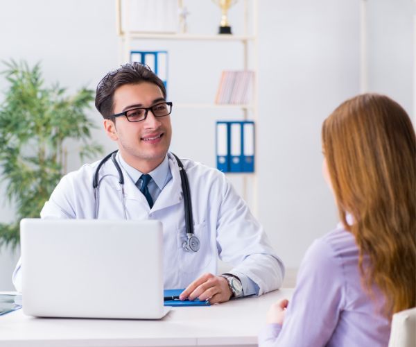 a woman talking with a doctor