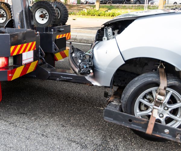 a car with front end damage being towed