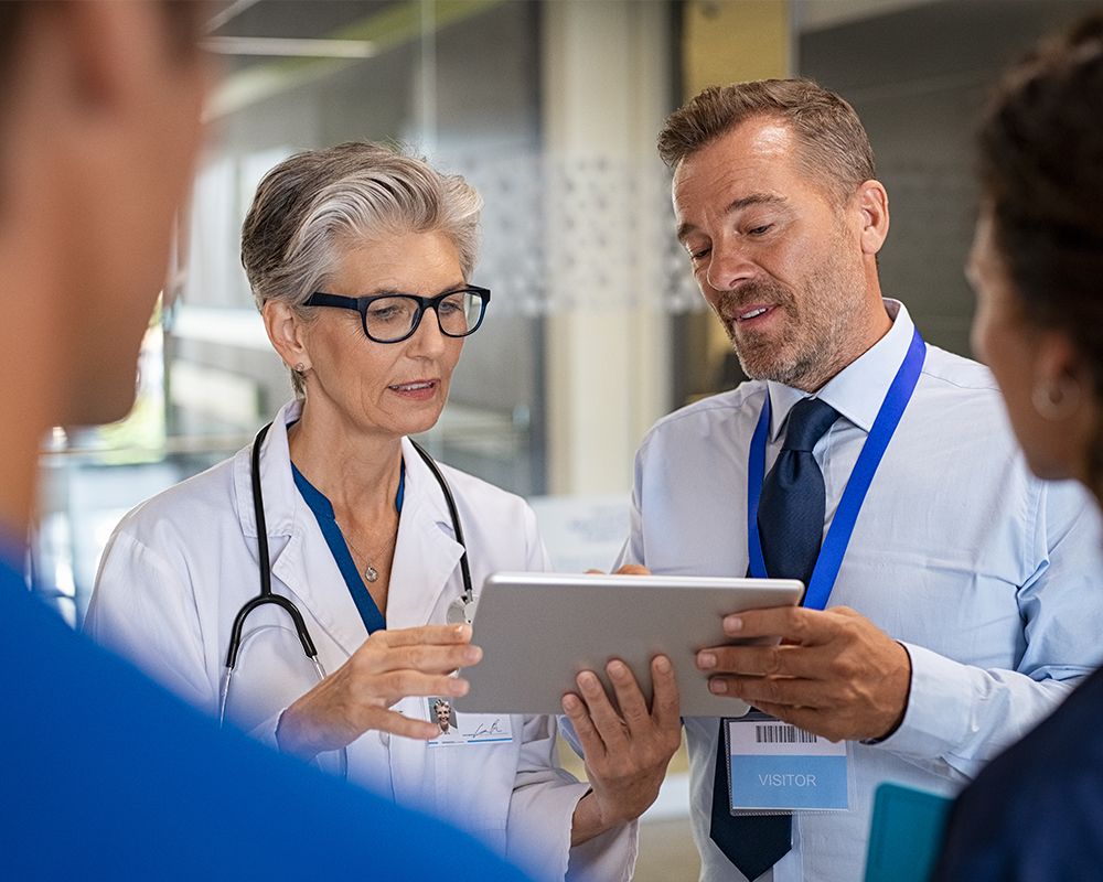 group of doctors looking at a tablet