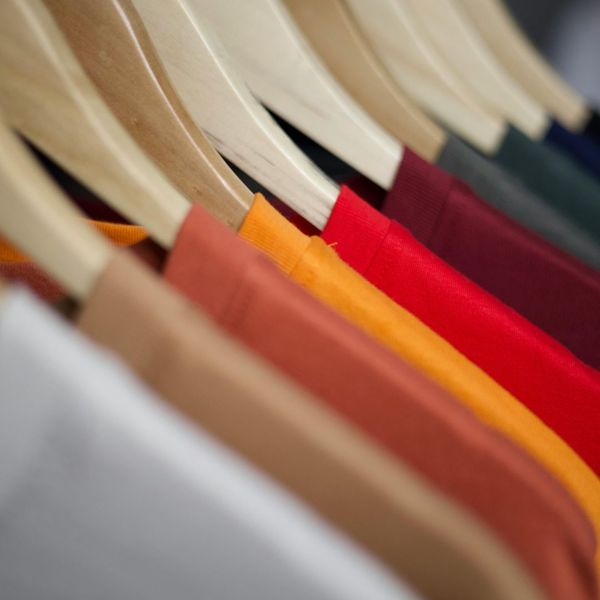 A row of hanging shirts. A row of hanging shirts.