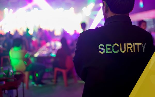 security guard monitoring a party with bright colorful lights