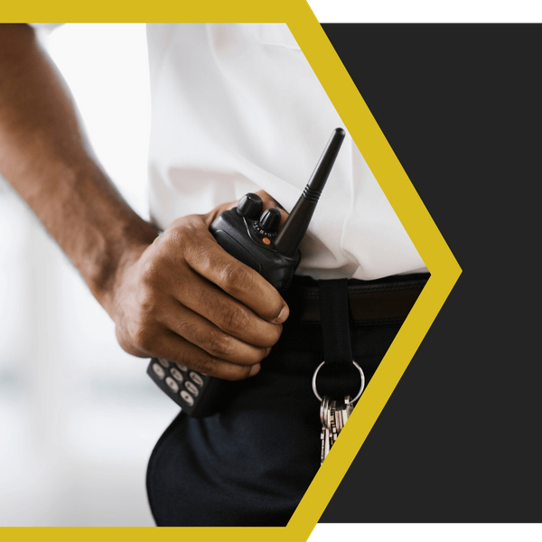 security guard with a hand on his radio