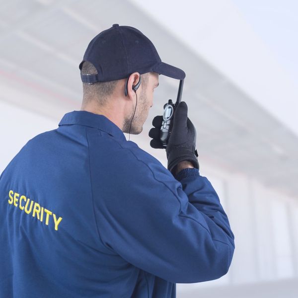 a security guard talking into a walkie-talkie Number One Trusted Crime Prevention (5).jpg