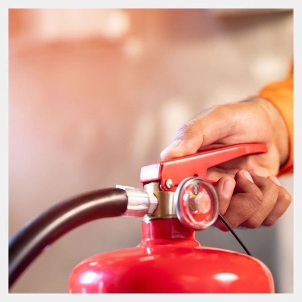 hand on a fire extinguisher