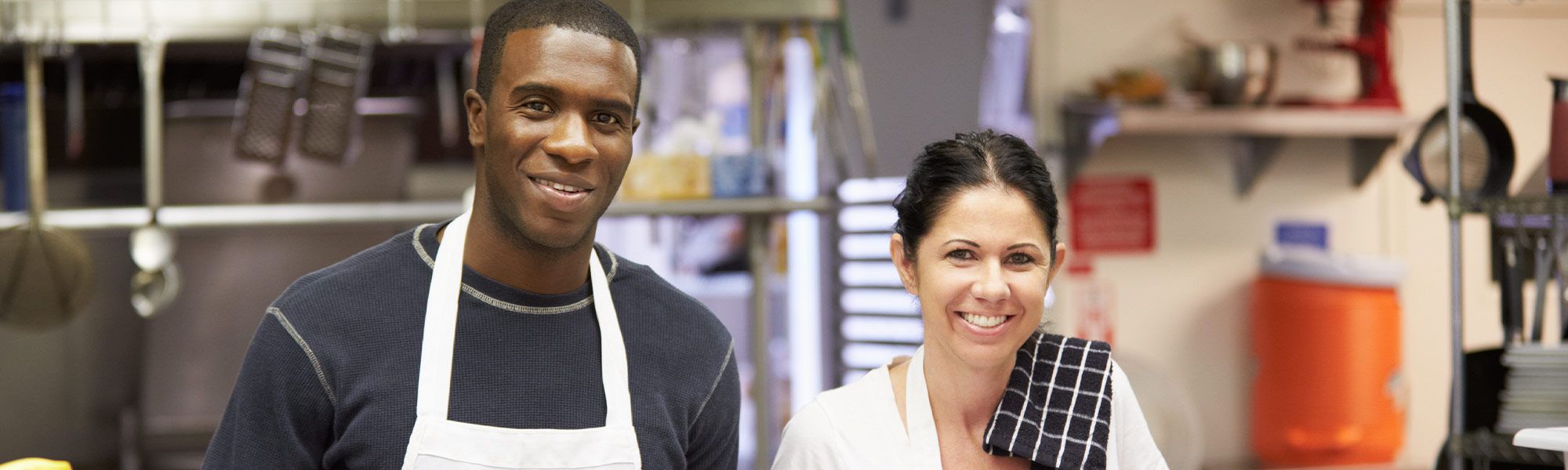 two volunteers working in a kitchen