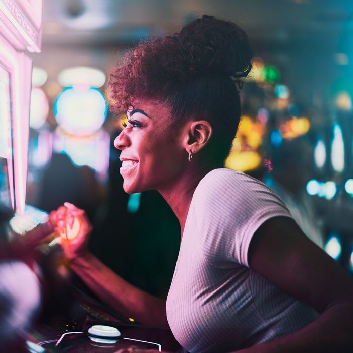 Happy woman playing a slot machine Happy woman playing a slot machine