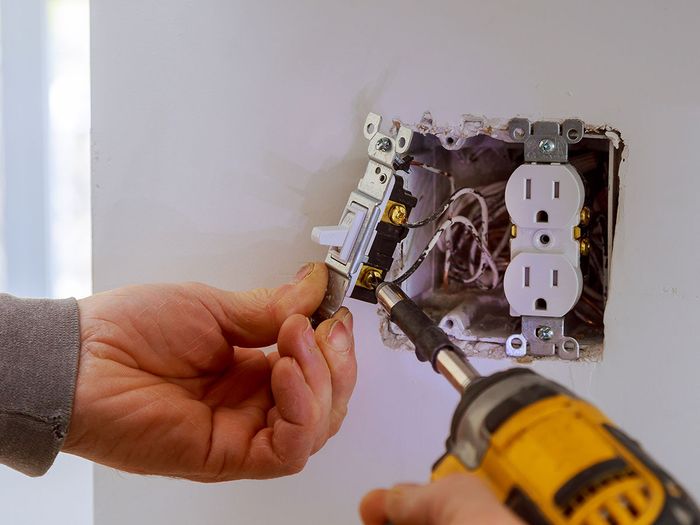 electrician working on an outlet