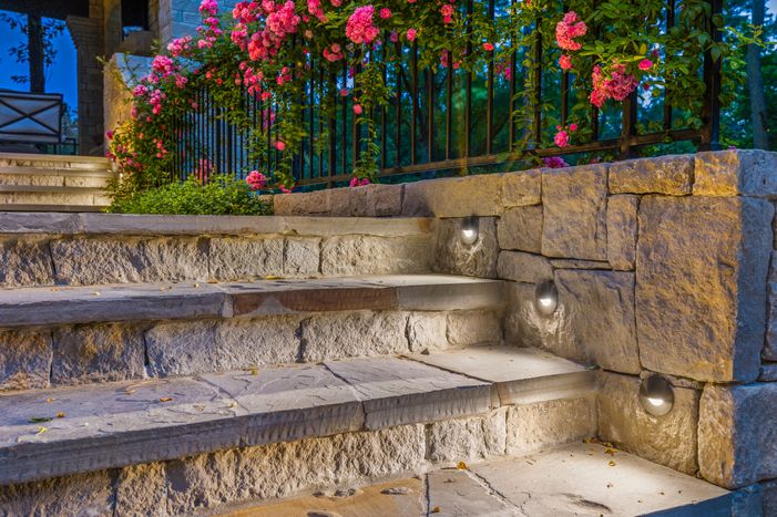 This image highlights a custom landscape lighting installation by Stirling Electric & Irrigation in Bellaire, Texas (ZIP 77401). The lighting design includes energy-efficient LED fixtures strategically placed to illuminate walkways, accent architectural features, and enhance the property's curb appeal after dark. Landscape lighting installation at a custom home in Bellaire, TX by Stirling Electric & Irrigation
