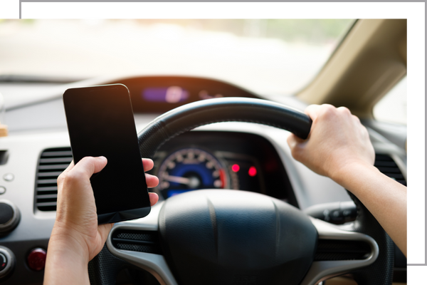 person on their cellphone in a car.