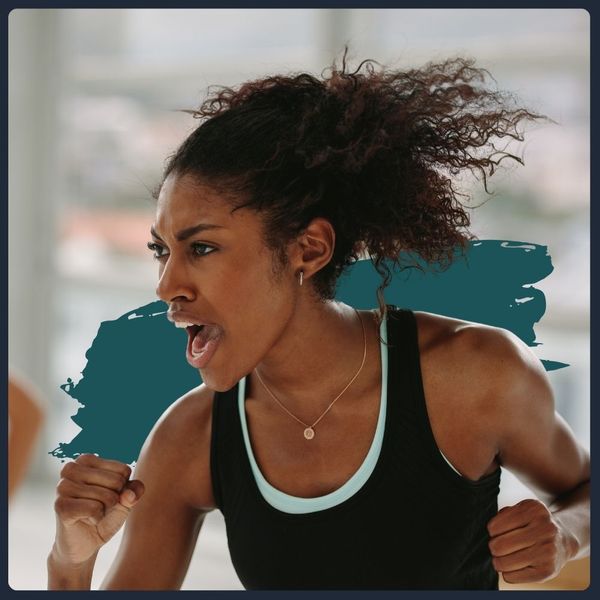 Energetic woman with curly hair, shouting during an intense workout.