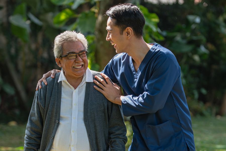 man and caregiver walking together at an assisted living facility man and caregiver walking together at an assisted living facility