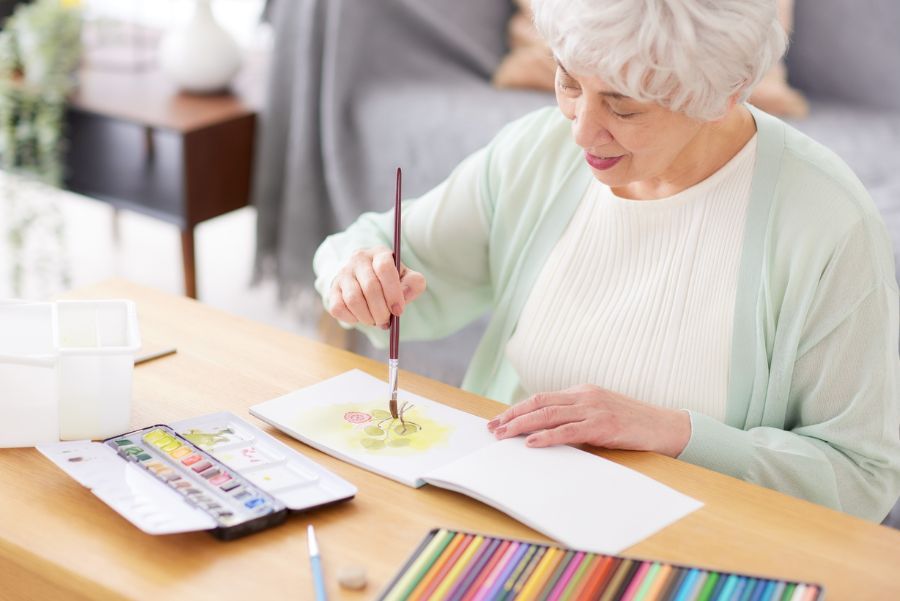 A senior woman painting 