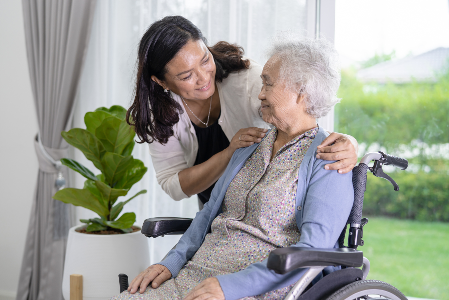 senior in a wheelchair with caregiver