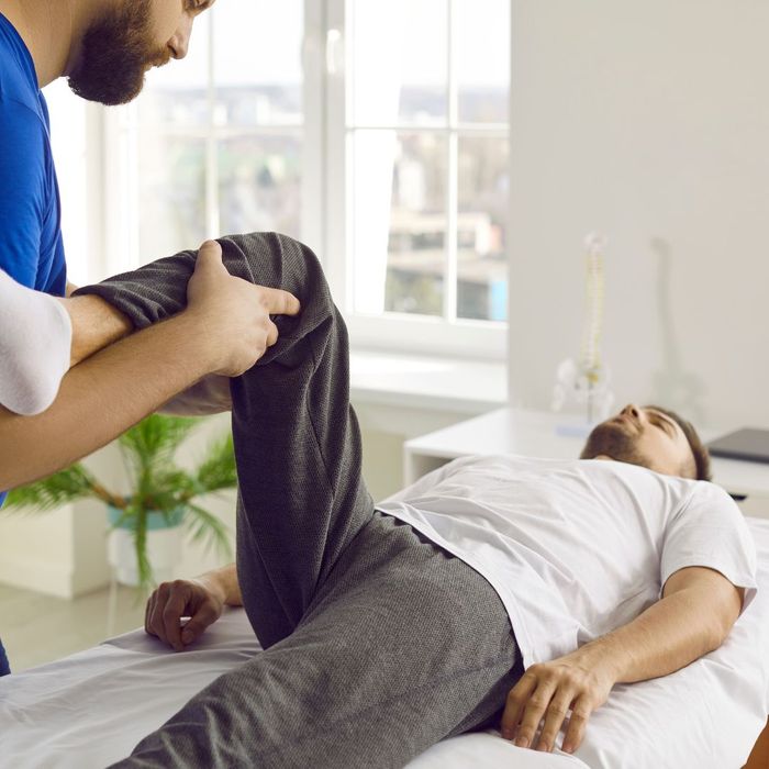 Chiropractor working with patient