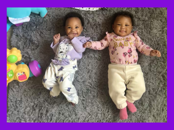 two infants laying side by side. 