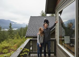 Couple and roofer at a mountain home