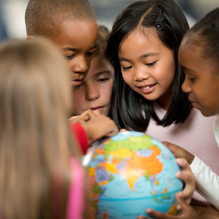 kids looking at a globe