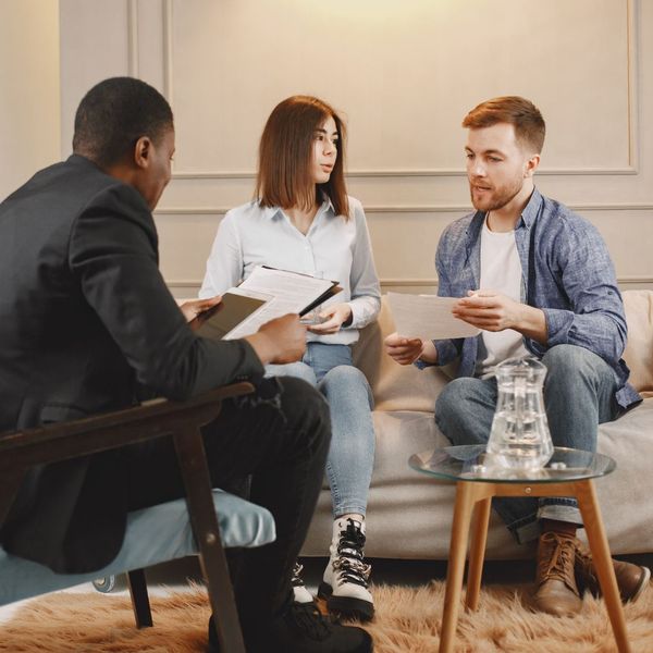 couple discussing paperwork with attorney