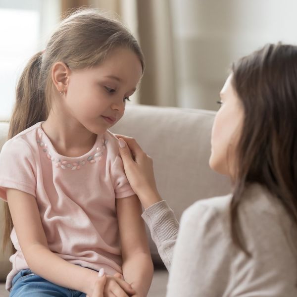 mother speaking with young daughter