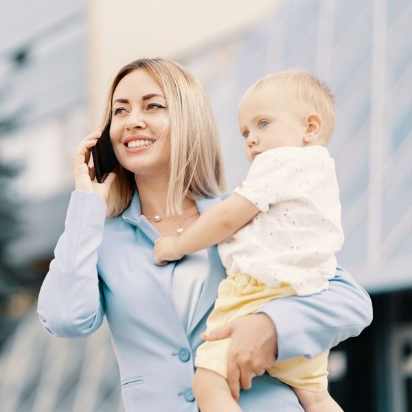 professional woman holding her young child