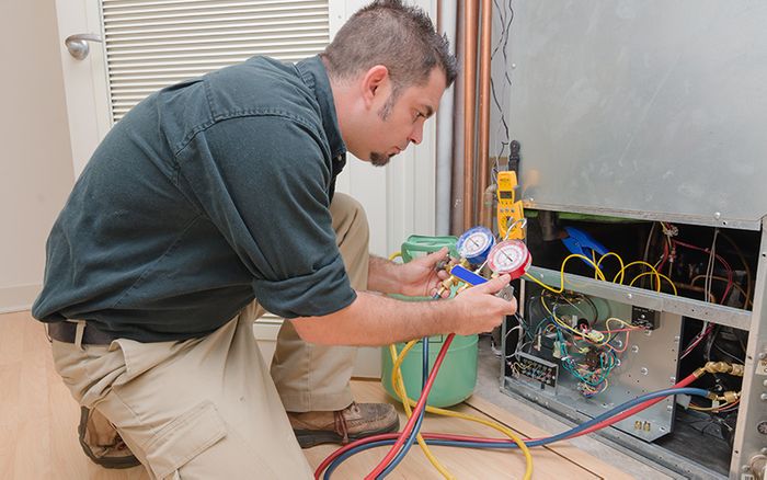 a worker repairing an HVAC system