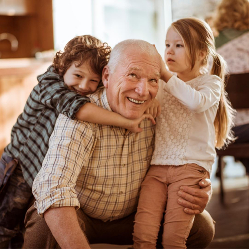 Smiling Grandfather playing with his grandchildren