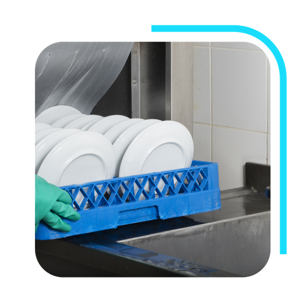 dishes being pushed into commercial dishwasher