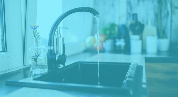 kitchen faucet running with blue color overlay