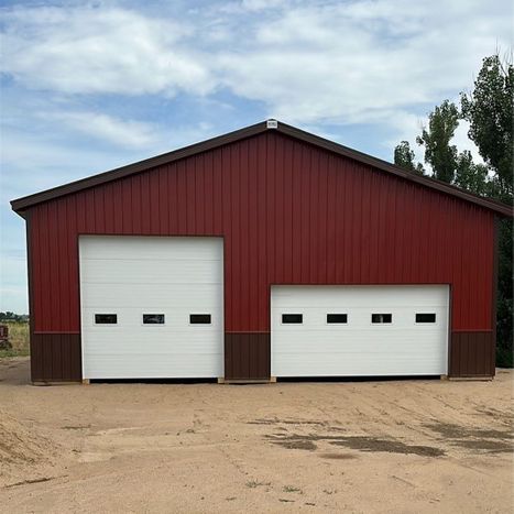 shed with garage doors by NoCo Buildings