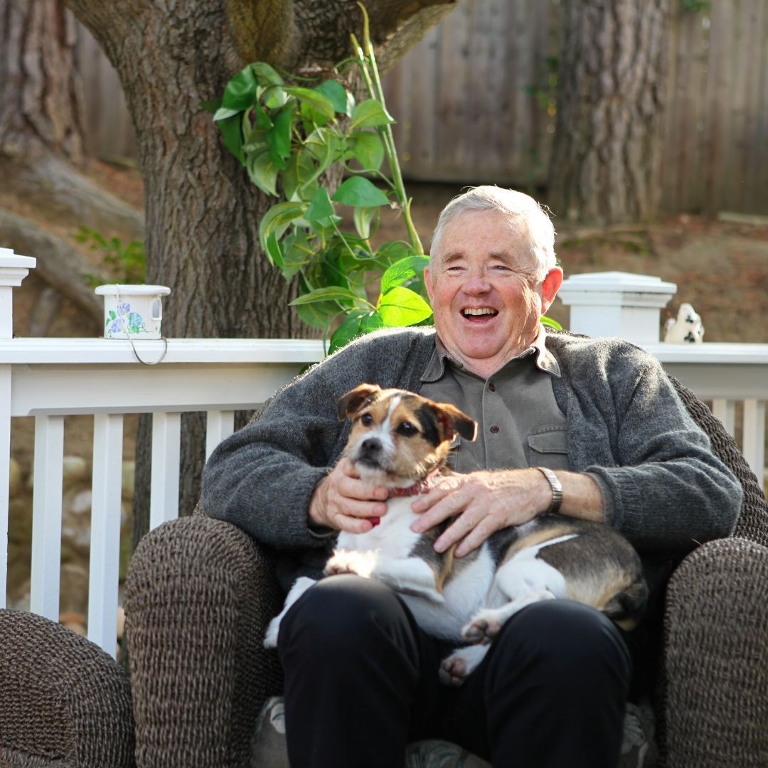 happy man on porch with dog