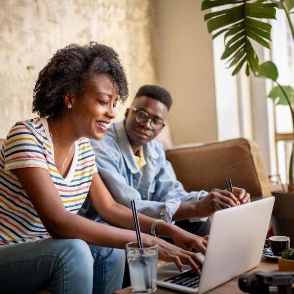 Man and woman on the computer in the living room