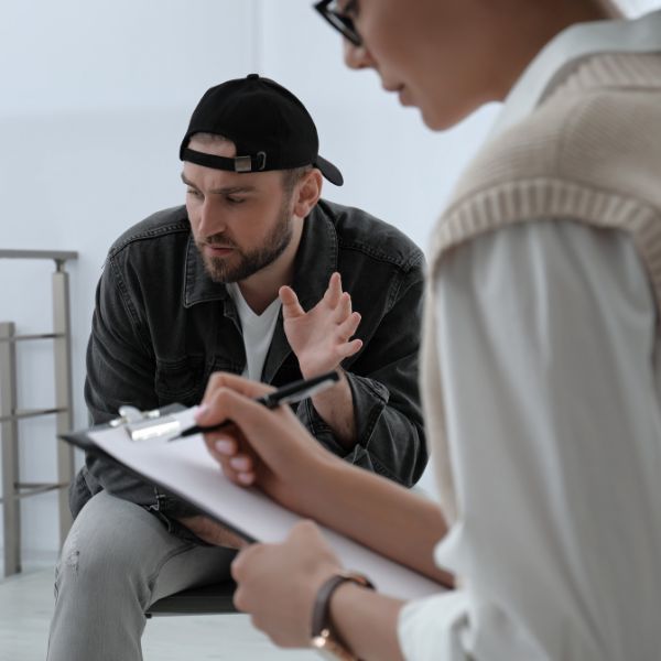 person looking at floor in therapy session