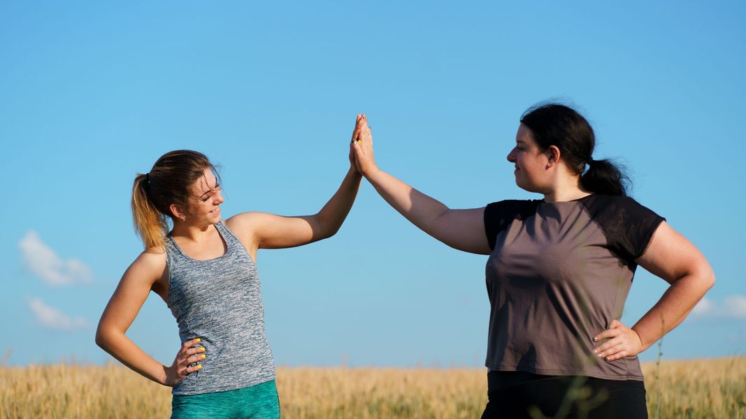 two woman high-fiving 