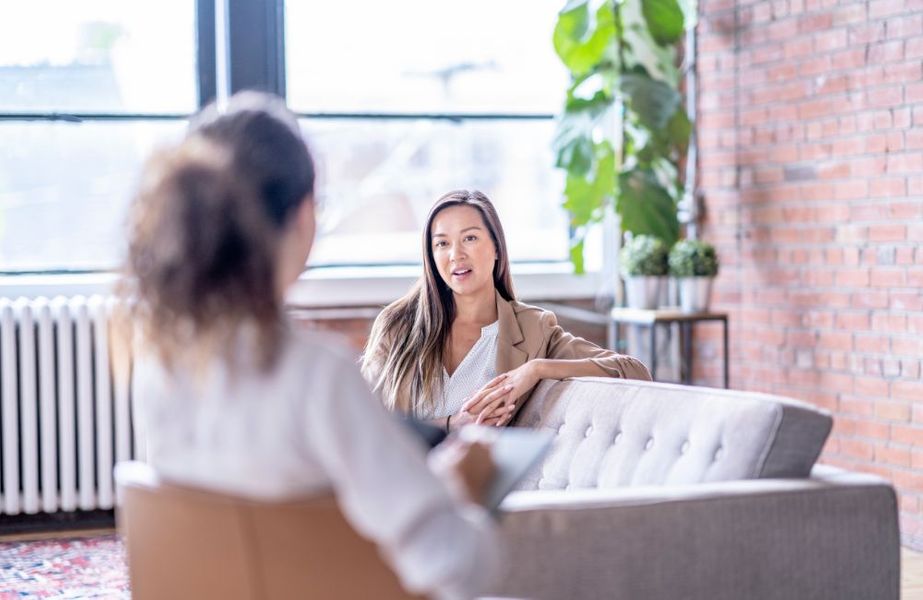 person talking to counselor in therapy