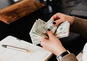 Person counting cash in hands