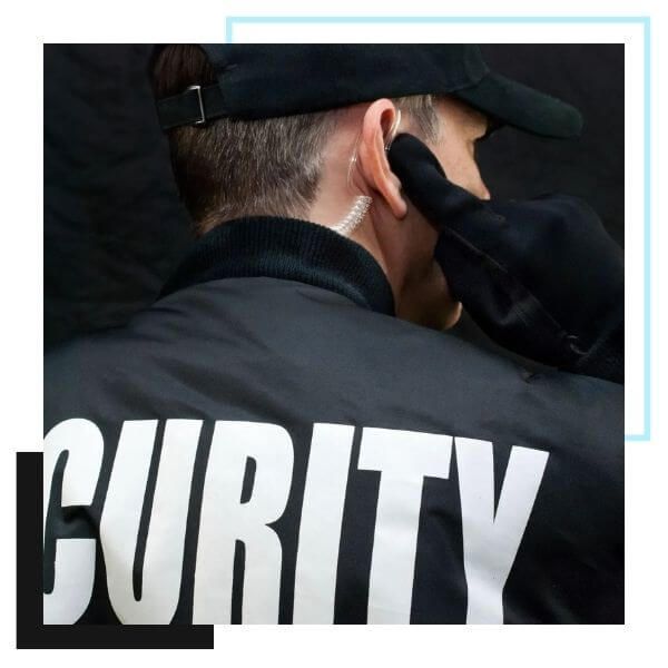back view of a security guard on his ear piece