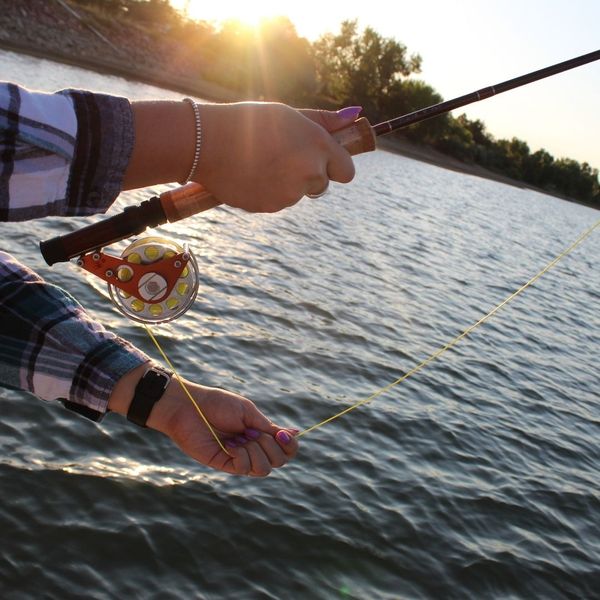 holding fishing rod over water