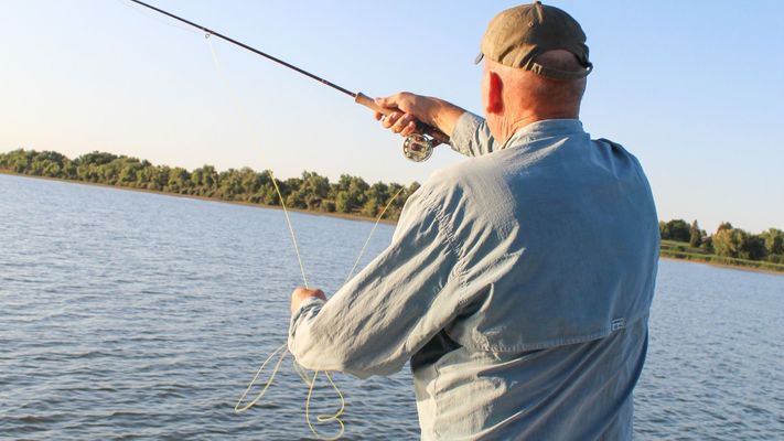 A man fishing on a lake