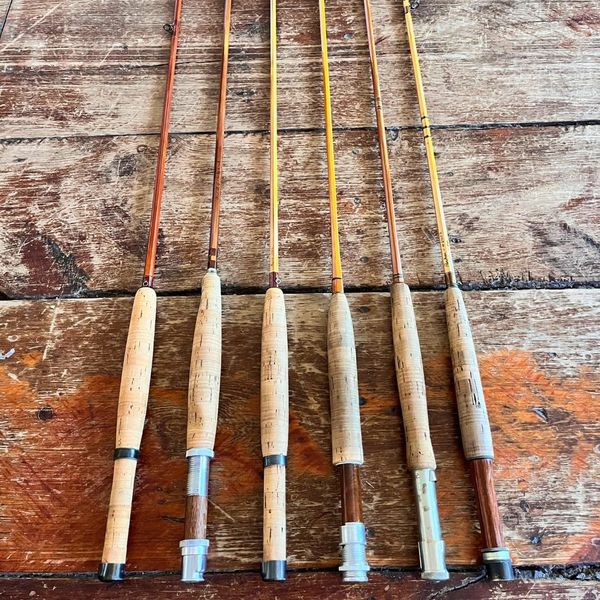 antique fishing rods on wooden table