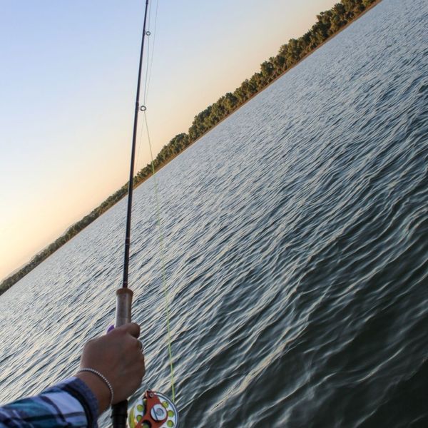 holding fishing rod over water