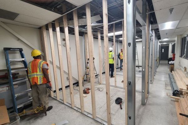 Construction crew framing interior walls during a federal design-build renovation project in the Maryland and D.C. area.