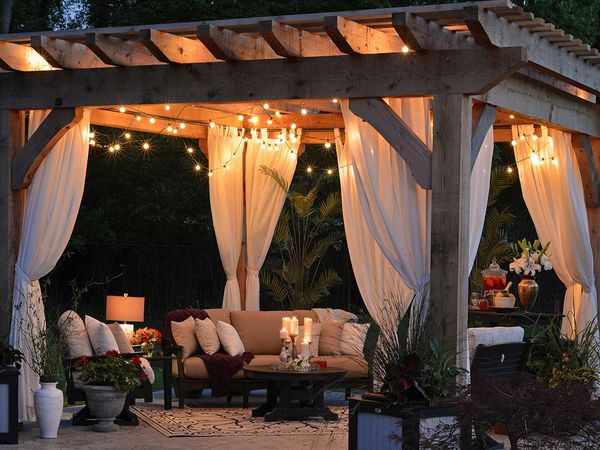  Backyard patio with pergola and ambiance lighting. 