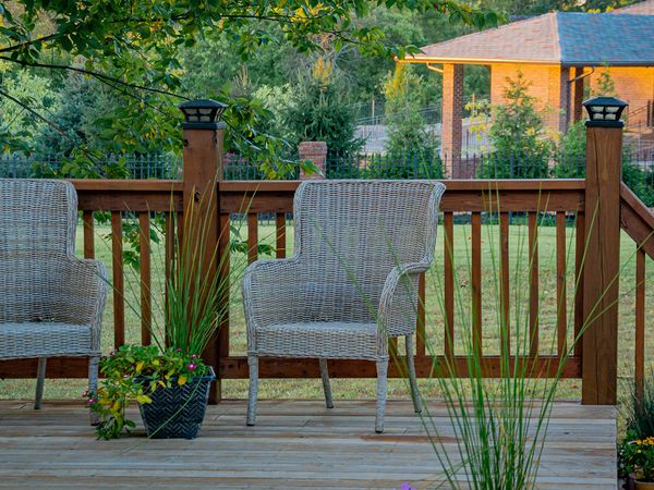 Backyard patio with two patio chairs. 